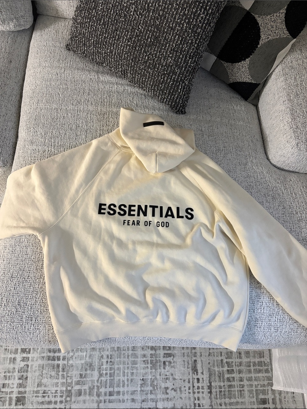 Fear of God ESSENTIALS Cream Hoodie with Black Logo